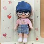  Doll with a pink shirt, blue denim hat, and skirt in a decorative box.